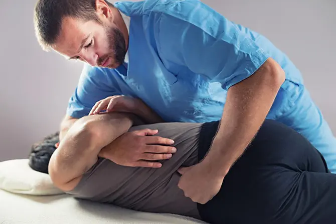 Chiropractor doing a back adjustment