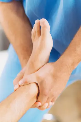 Chiropractor doing foot ankle adjustment for patient with foot pain