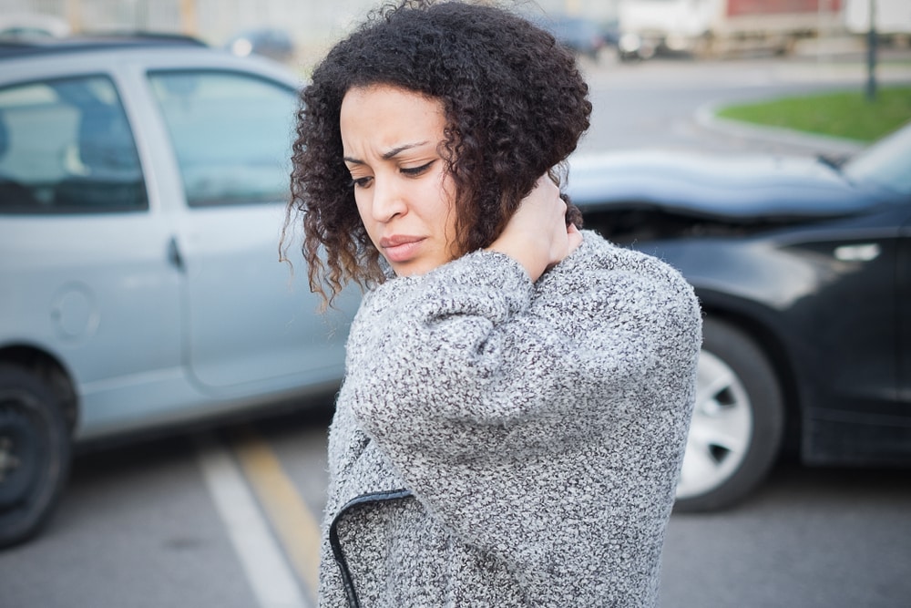 Woman suffering from whiplash due to an auto accident.