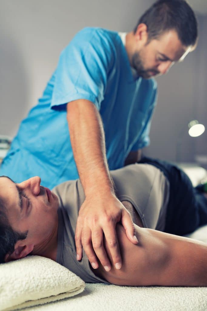 chiropractor working on a patient with back pain
