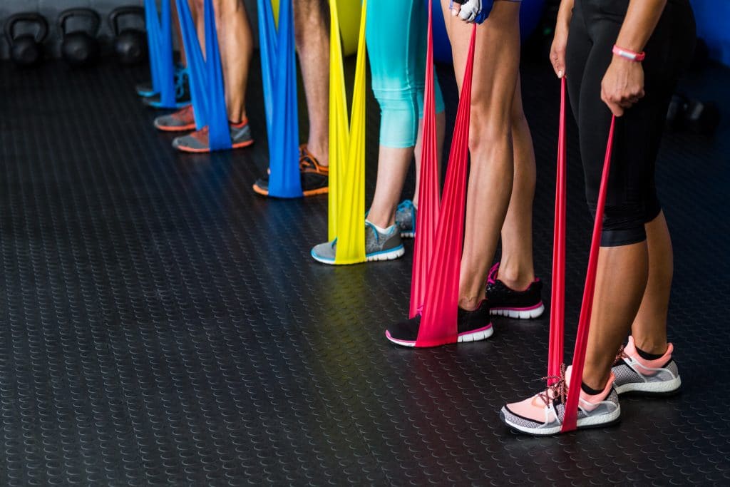 Athletes excising with resistance bands for physical therapy.