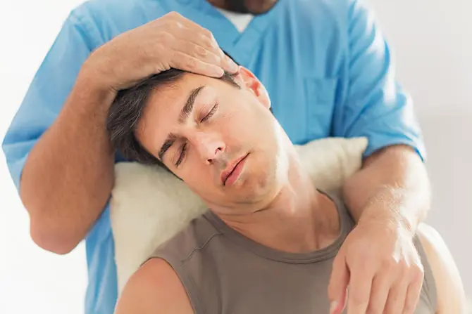 Chiropractor working on a patient with neck or head pain.