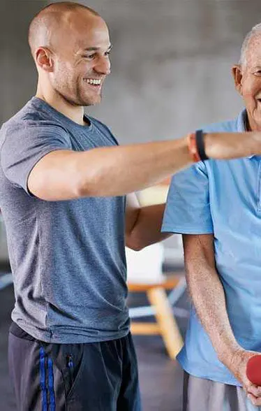 Physical therapist directing an elderly man for post surgery physical therapy.