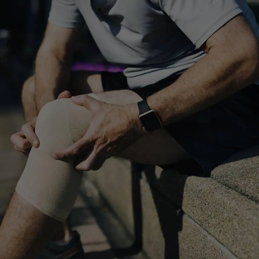 Man holding his knee due to pain