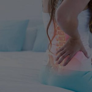 woman sitting on her bed having lower back pain