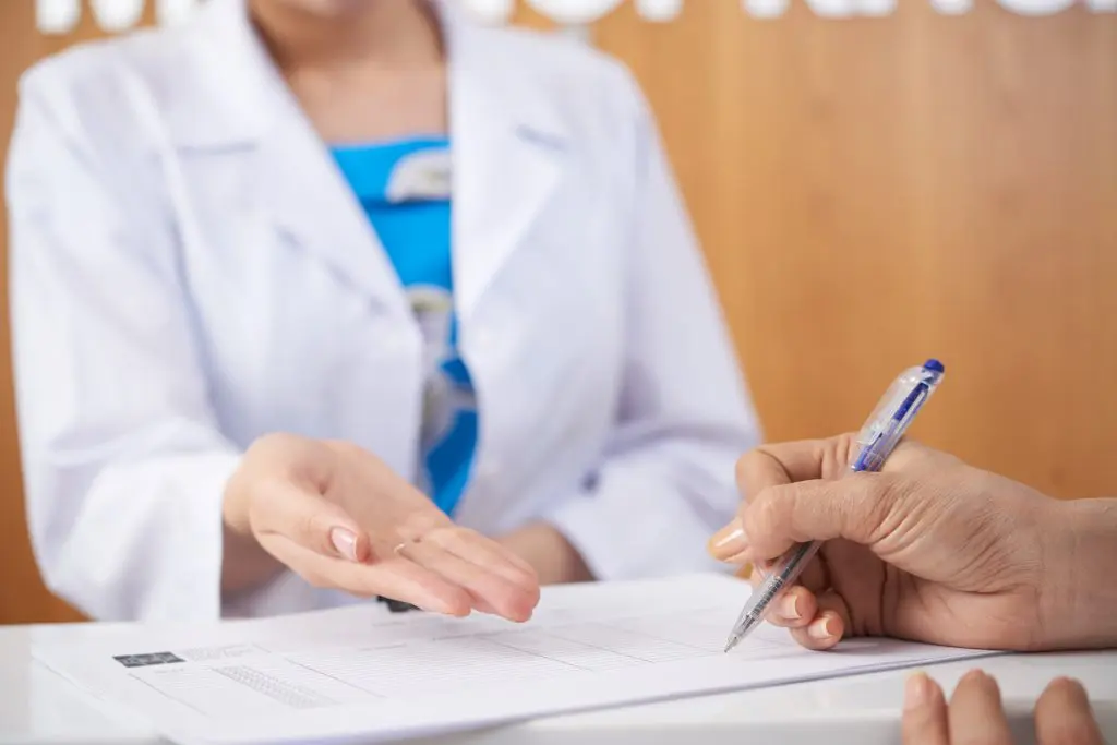 Female patient filling medical documents