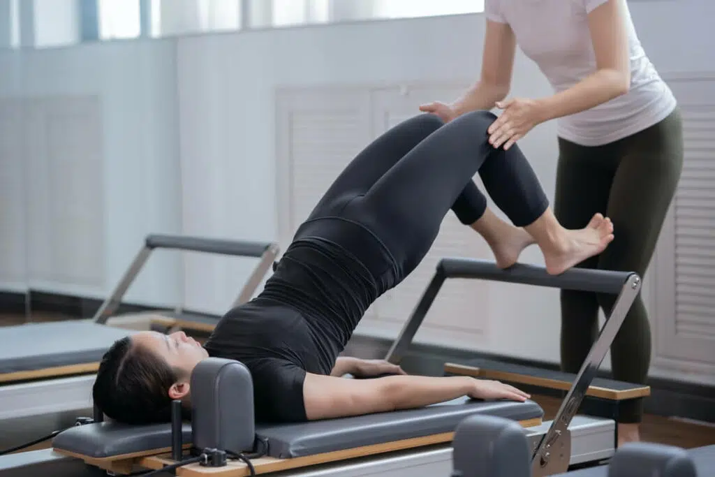 Physical therapist helping a patient do lumbar exercises..