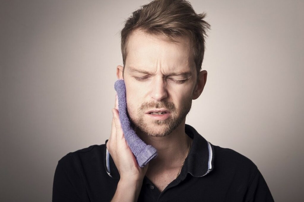 Young man experiencing TMJ pain