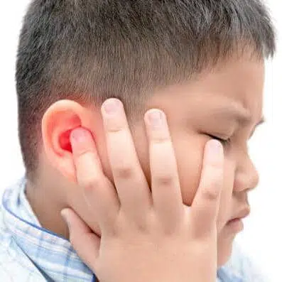 Young boy suffering from an ear infection