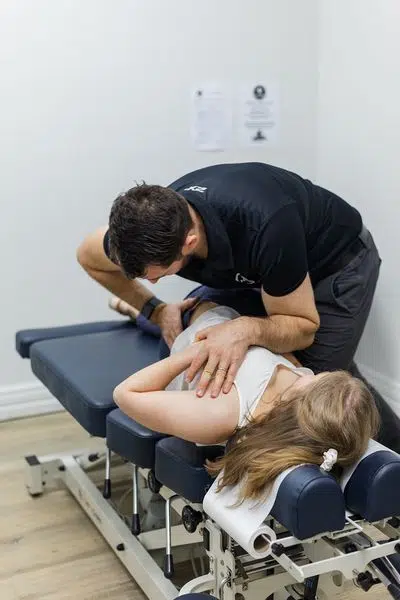 Chiropractor is doing some chiropracrtic adjustment to then patient 