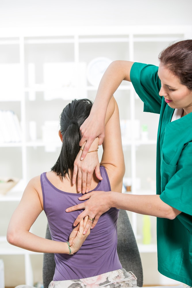 Chiropractor doing some chiropractic assessment to the patient 