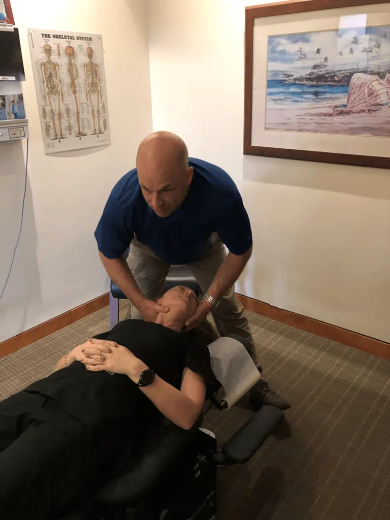 Dr. Hogan doing a chiropractic adjustment in the  cervical spine