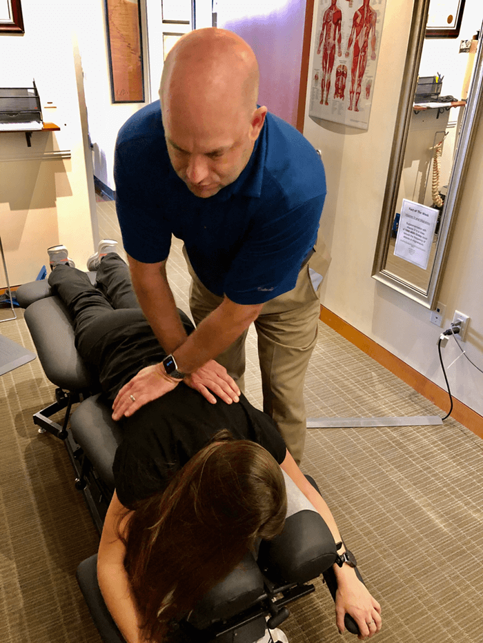 Dr Hogan doing chiropractic adjustment