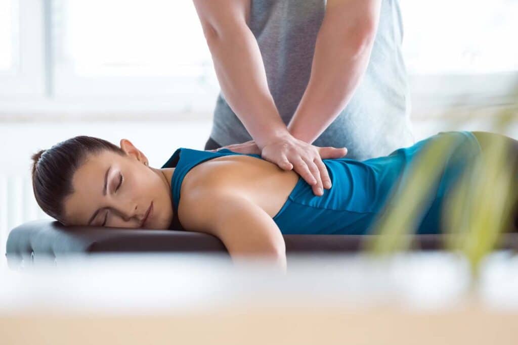 Chiropractor treating a patient who suffers from back pain