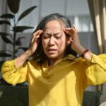 Elder woman is suffering from Head ache and migraines 