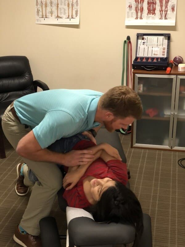 Chiropractor doctor at Sugar Land doing some chiropractic adjustment to the patient.