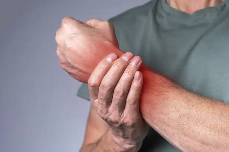 man suffers from chronic pain having a painful swelling arms.