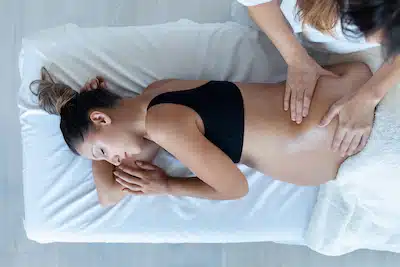 pregnant woman getting chiropractic care for relief in Pregnancy Discomforts
