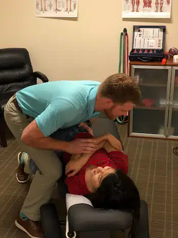 chiropractor at hogan spine and rehabilitation treating patient with shoulder pain