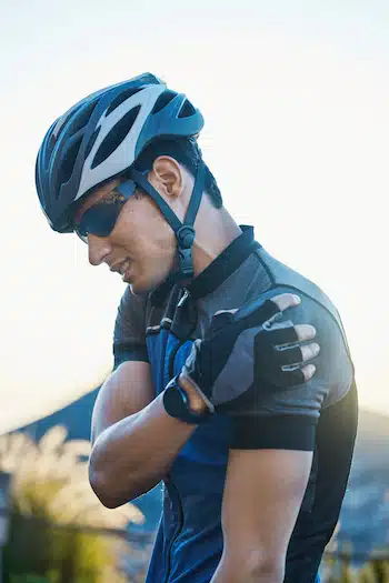 cyclist experiencing shoulder pain from Rotator Cuff Tendonitis and frozen shoulder after a long ride