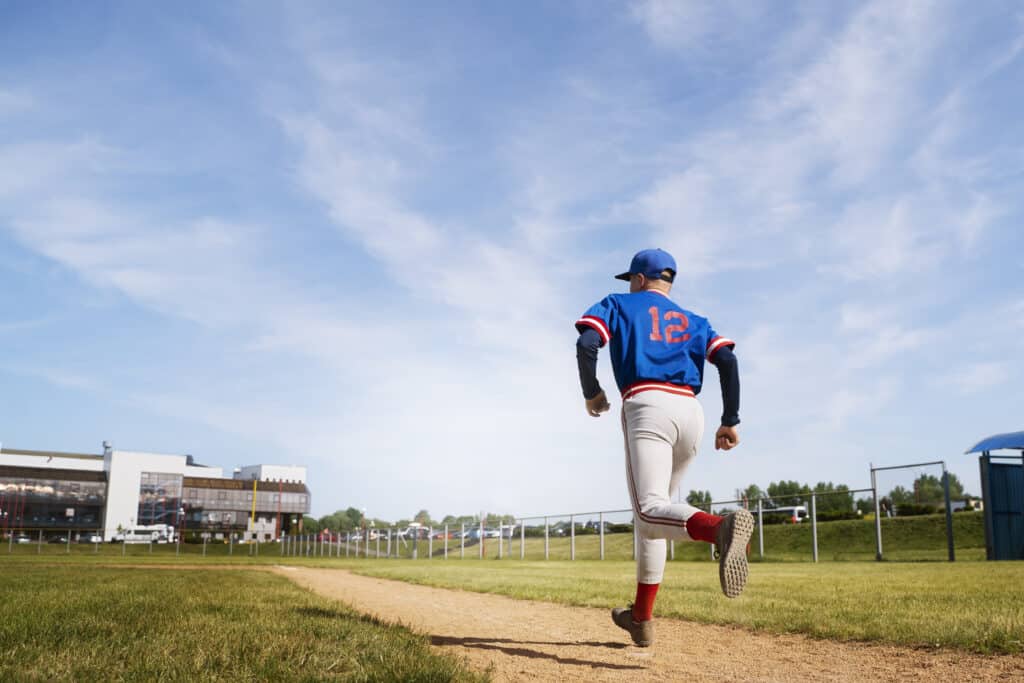 a man playing baseball as a summer activities in Sugar Land