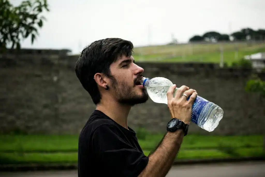 Man Wearing Black Shirt Drinking Water